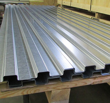 A picture of a silver roof piece produced from our shearing and large metal cutting services.